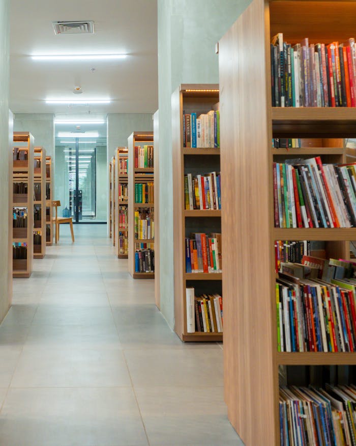 Spacious library interior with neatly arranged bookshelves in Jakarta.